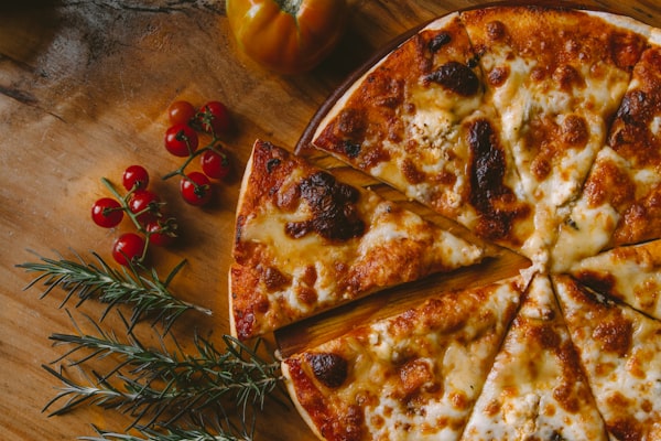 Pizza being prepared in restaurant kitchen
